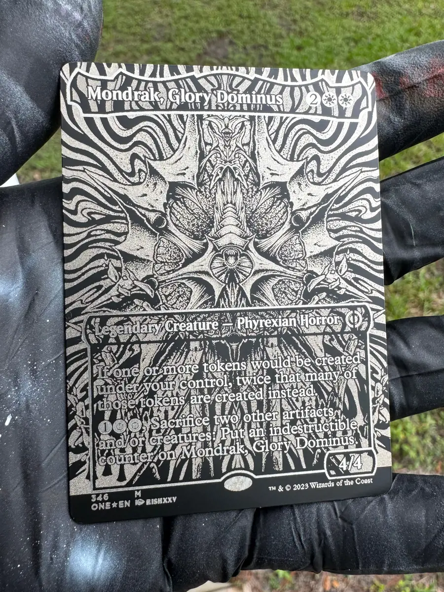 Mondrak, Glory Dominus, engraved into a stainless steel plate and held in the hand